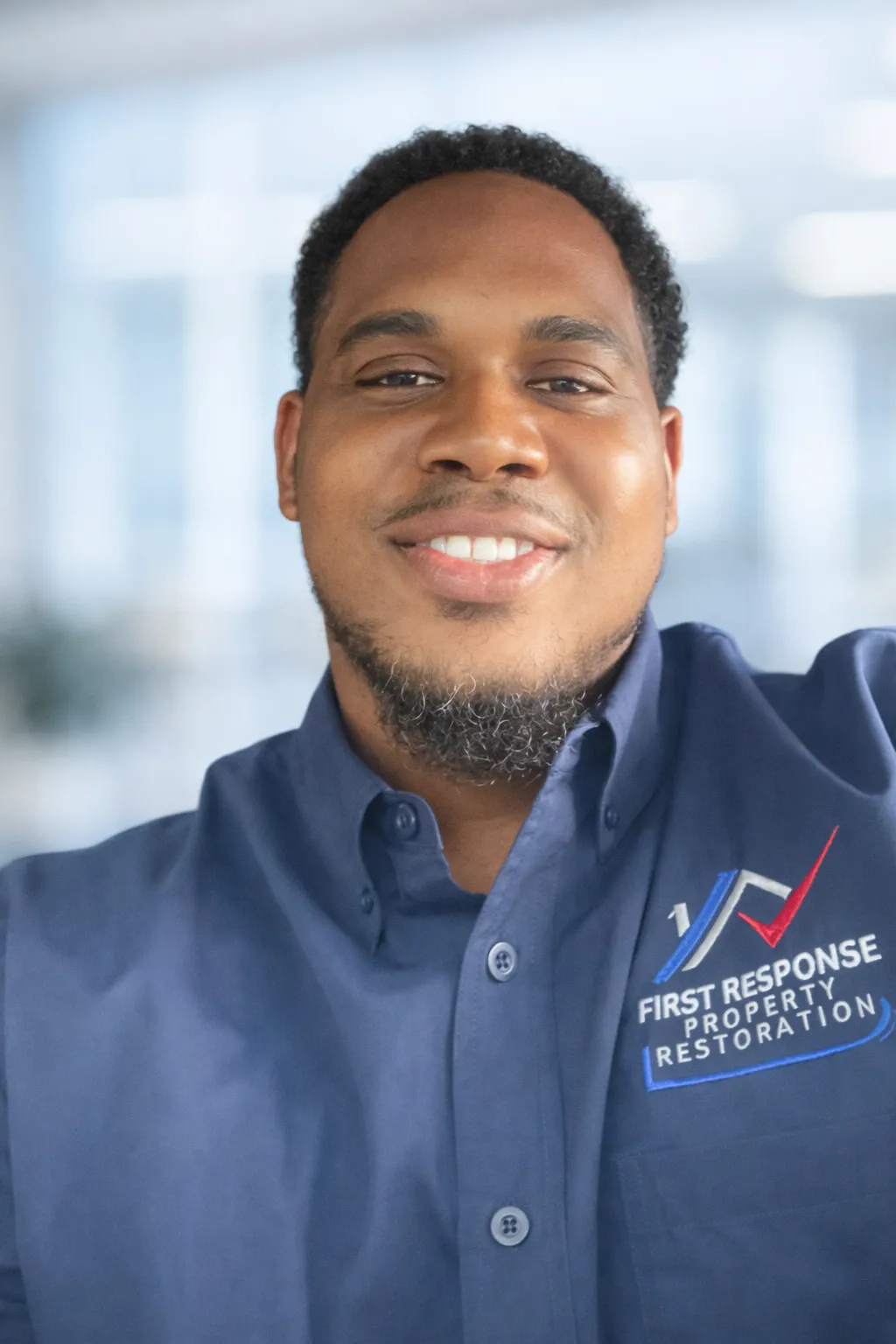 Fred Terrell, owner of First Response Property Restoration, in branded company shirt