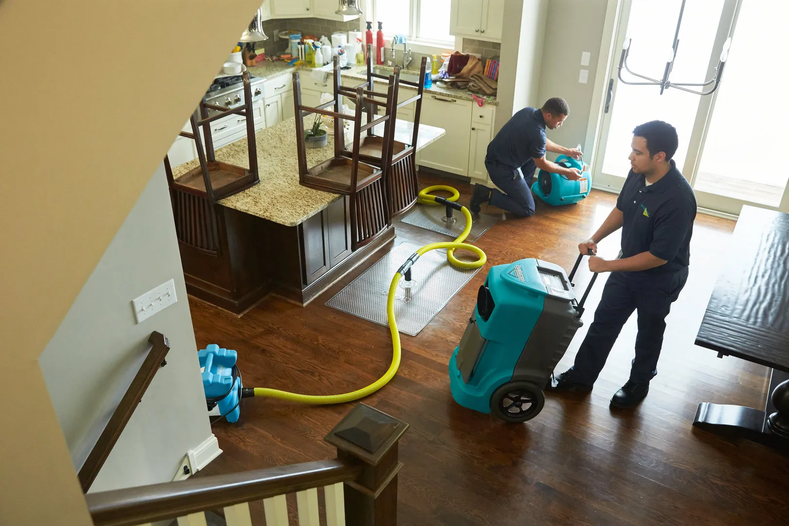 First Response Property Restoration technicians performing water damage extraction with commercial-grade equipment